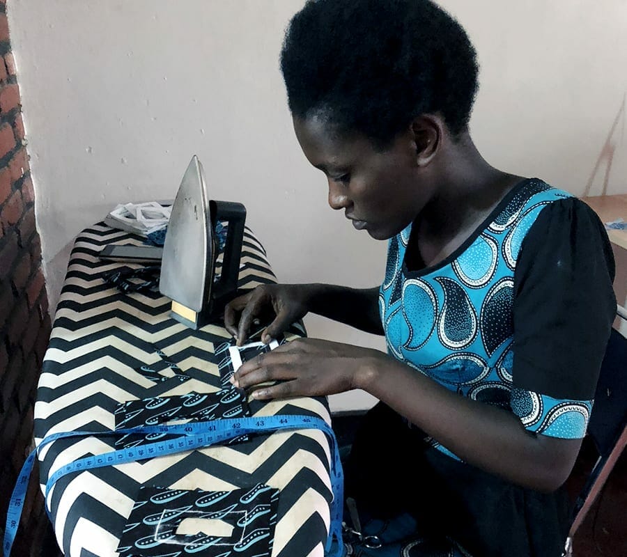 A member of Ki-Pepeo irons her handmade corporate gifts