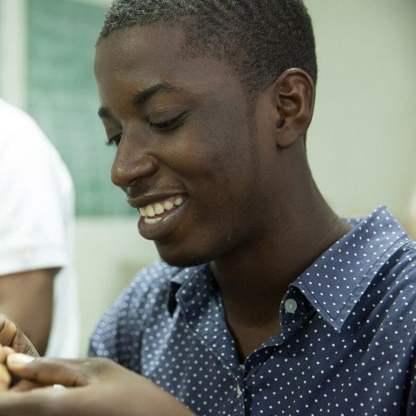 young man smiling blue shirt