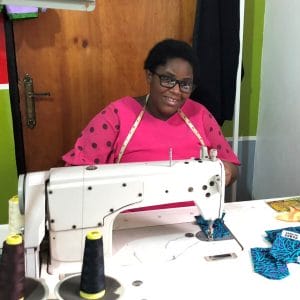 lady in pink dress at sew mach