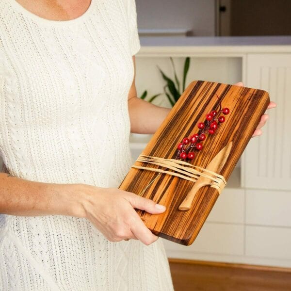 Woman holding cutting board with knife