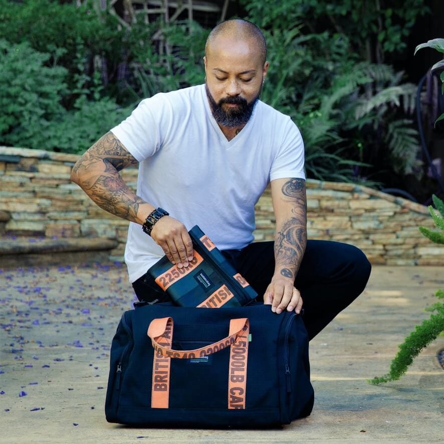 Moving in Style A model places a branded logo bag into a larger branded logo bag.