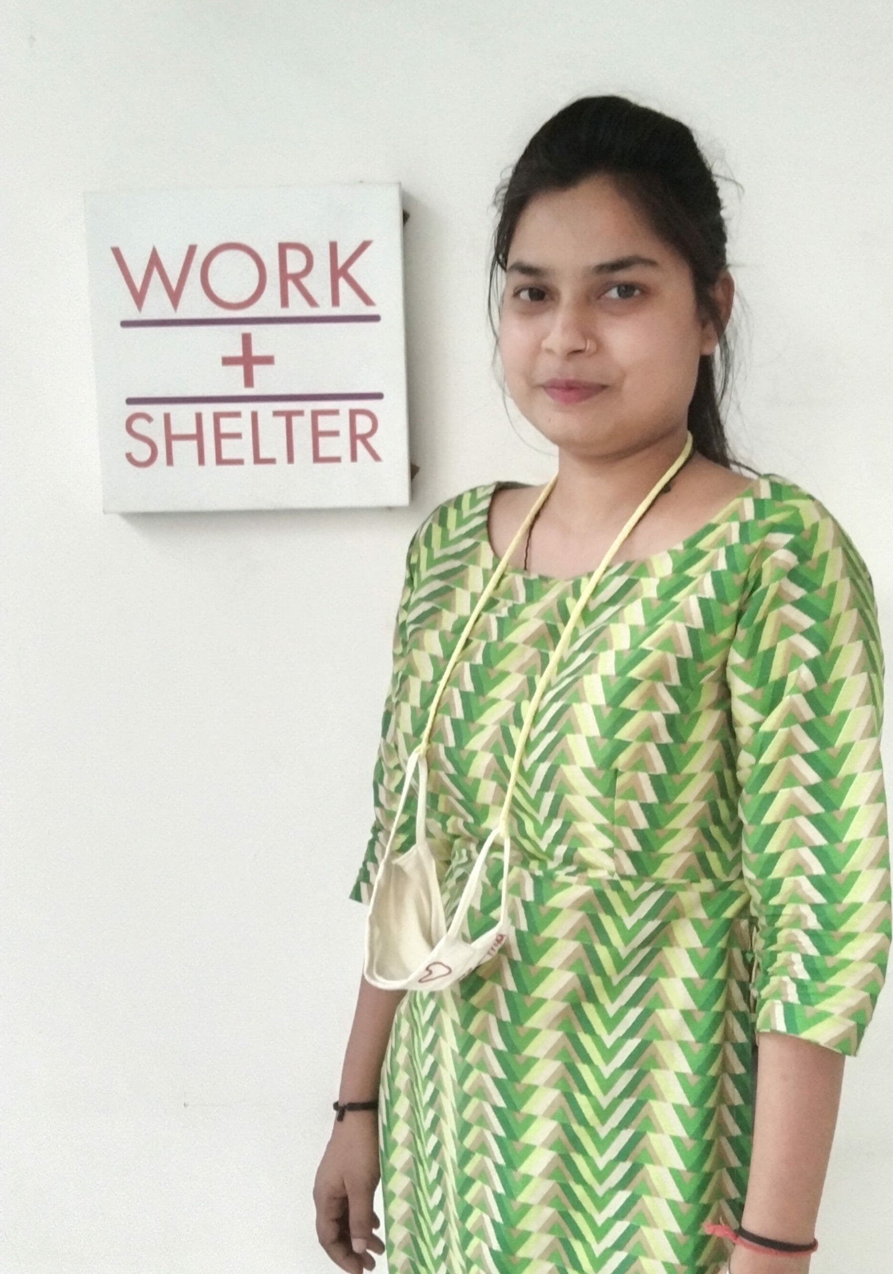 Hema, who helped to make Levi's reusable shopping bags bulk, stands next to a sign that reads Work+Shelter