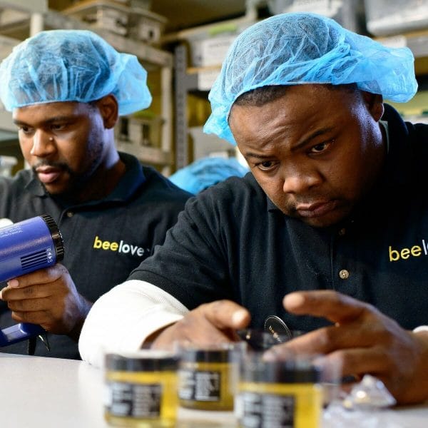 Your Breakfast Joy corporate coffee gifts include BeeLove honey, made by workers like the two men shown.