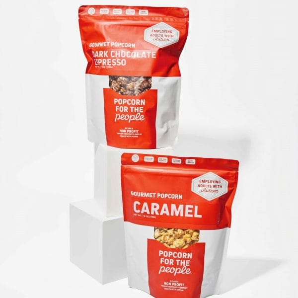 Our domino game gift set includes popcorn, shown here in Dark Chocolate Espresso and Caramel flavors.