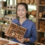 Our domino game gift set was crafted by artisan collective Waraporn Kamshuk, led by the woman pictured here.