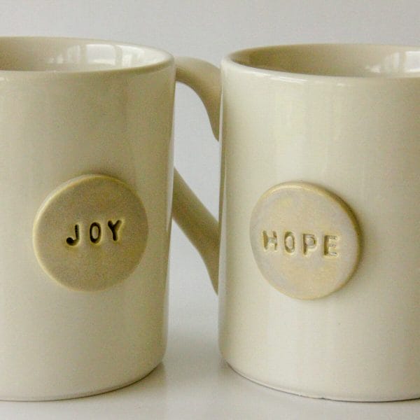 Our "It's Tea Time!" corporate tea gifts include a handmade ceramic mug, such as the two shown here, one stamped with the word Joy and the other stamped with the word Hope.