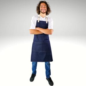 A man models a custom apron with logo with his arms crossed and smiling