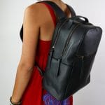 Side view of our leather backpack for travel in black.