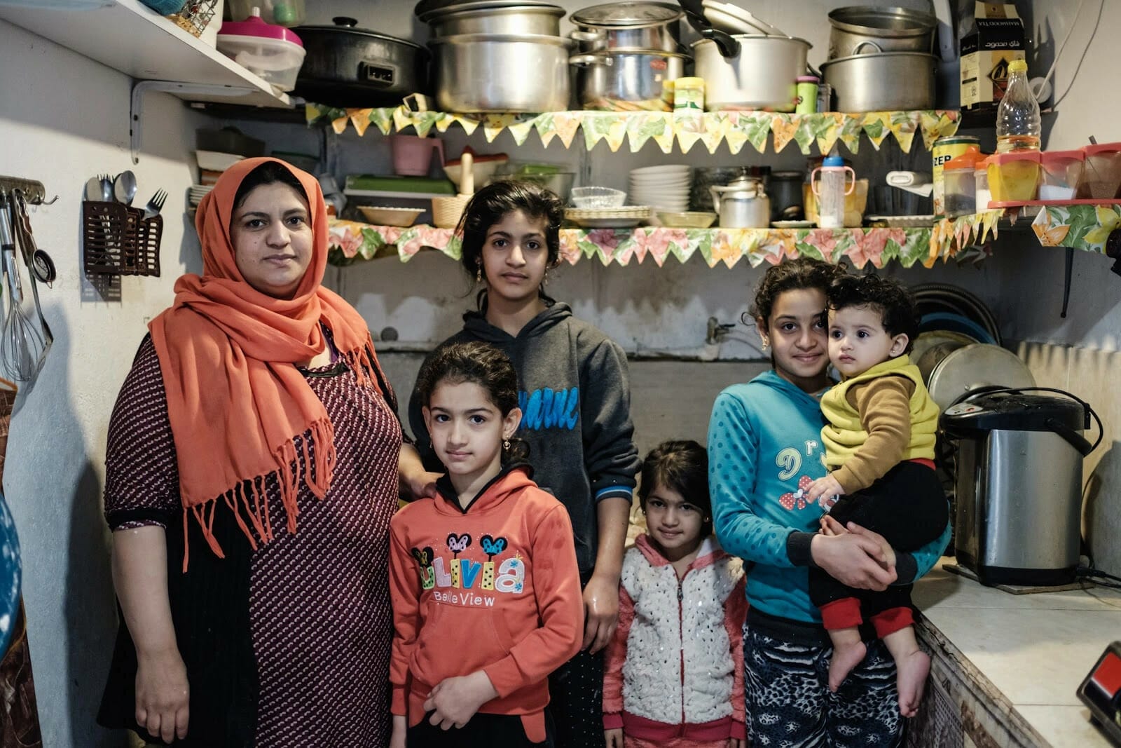 Delvin and her five children in their small kitchen