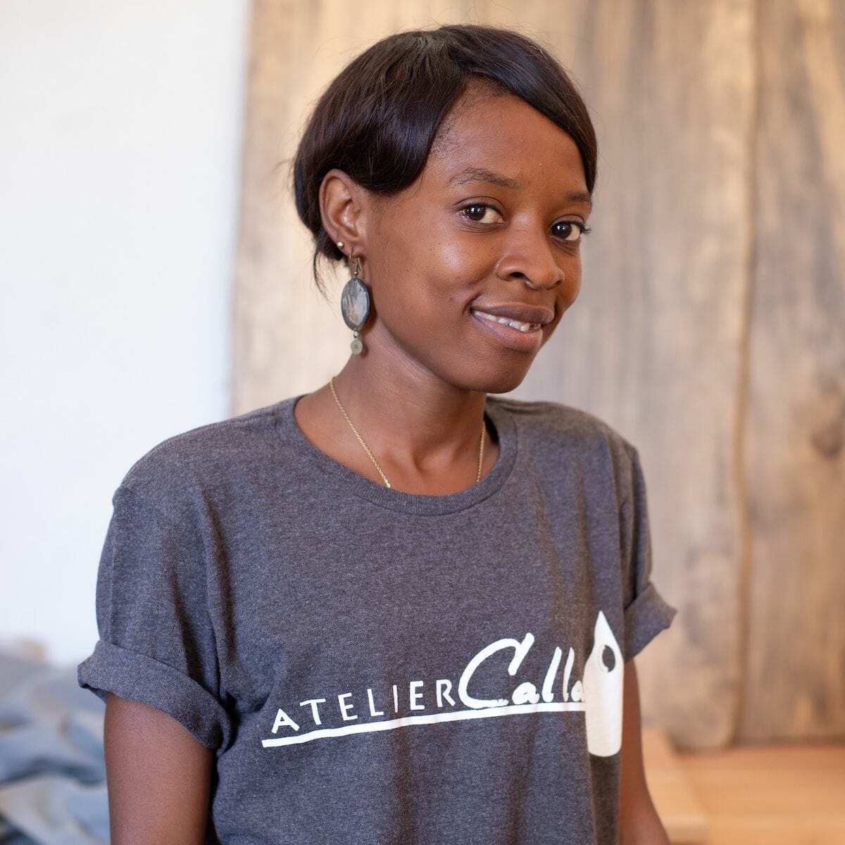 A woman from Atelier Calla who creates gifts from Haiti smiles at the camera.