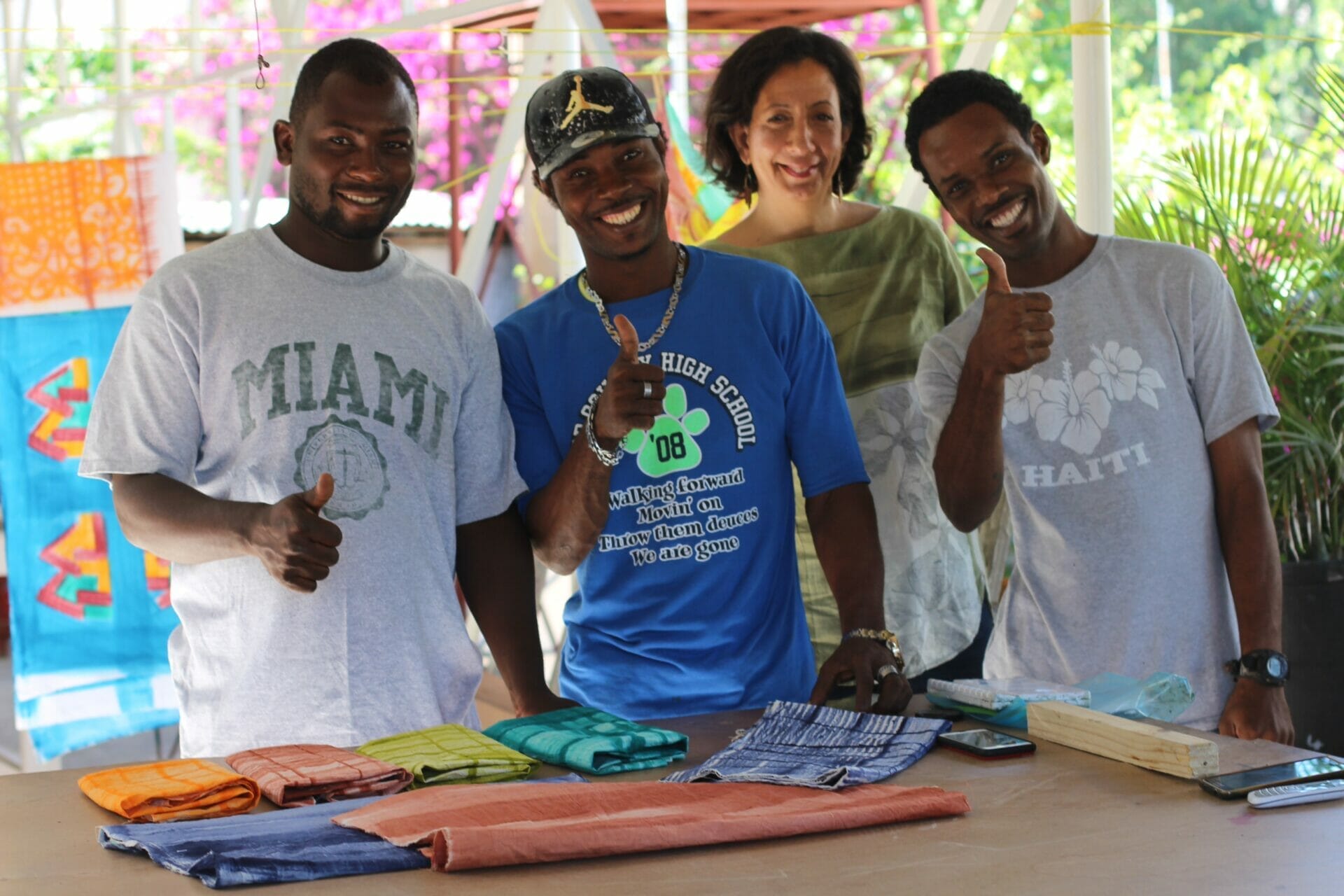 A team from Sandilou poses with gifts from Haiti that they created.