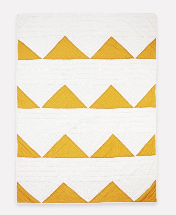 triangle quilt throw mustard flatlay